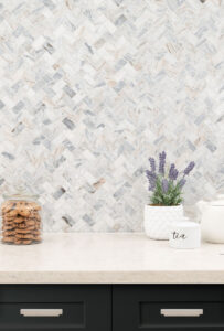 Capri Blue 1×2 Herringbone Honed Subway styled in a finished room