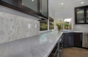 Carrara White 1×2 Herringbone Honed styled in a finished room