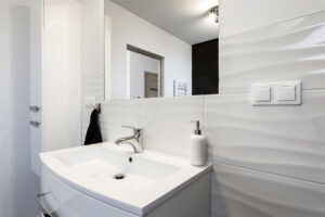 Dymo Wavy White 12×24 Glossy styled in a finished room